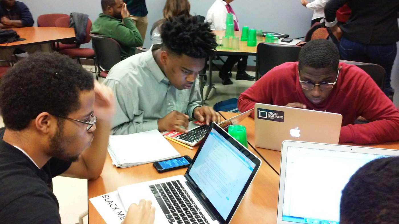 Morehouse College freshmen Philip Rucker, Damon Redding and Tyree Stevenson use a programming language called Python to plot a map of weather stations in the United States.
